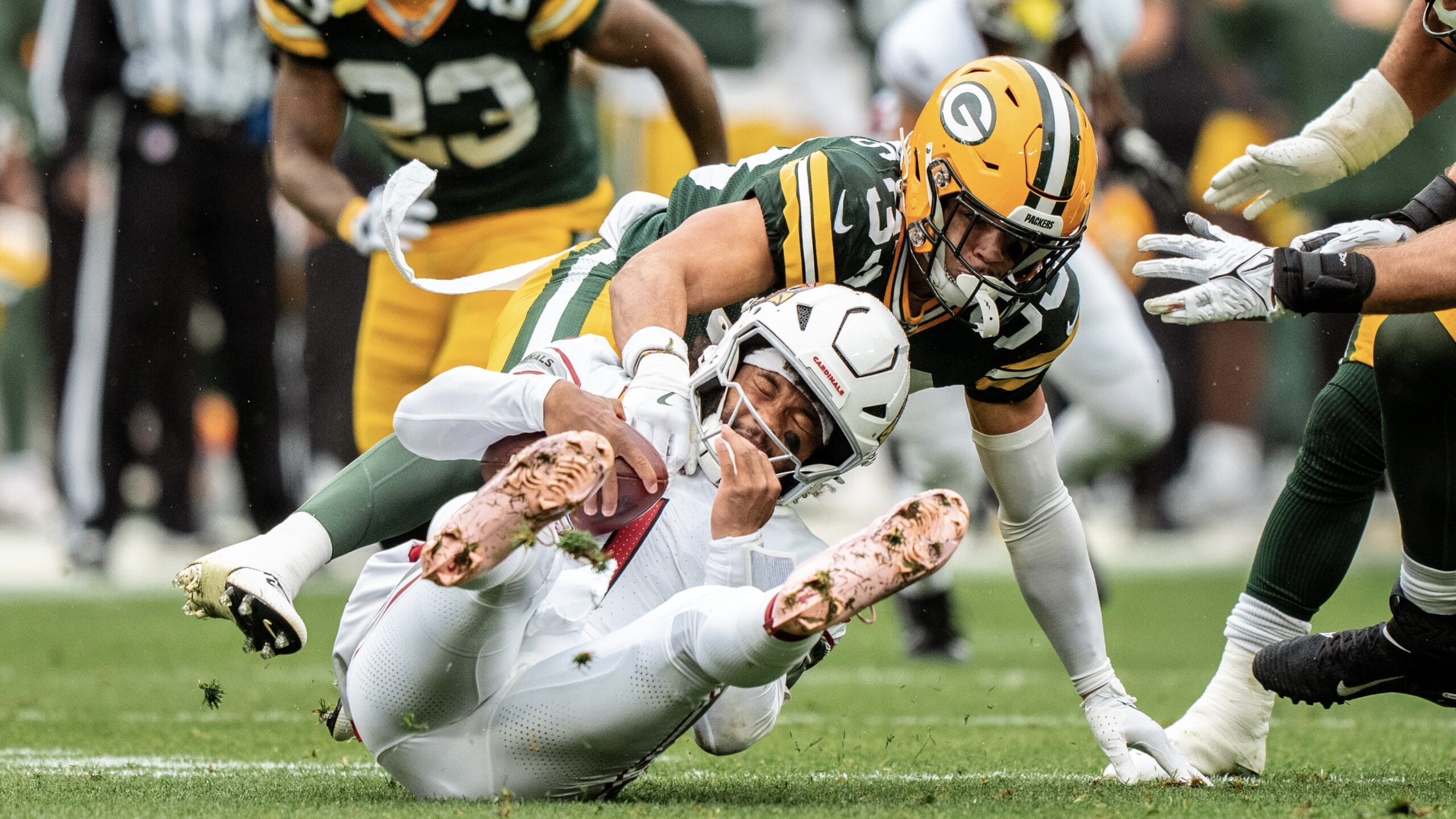 GREEN BAY, WI - OCTOBER 13: Safety Evan Williams #33 of the Green Bay Packers takes down Quarterback Kyler Murray #1 of the Arizona Cardinals during the second quarter of an NFL football game, Sunday at Lambeau Field on October 13, 2024 in Green Bay, Wisconsin. (Photo by Todd Rosenberg/Getty Images)