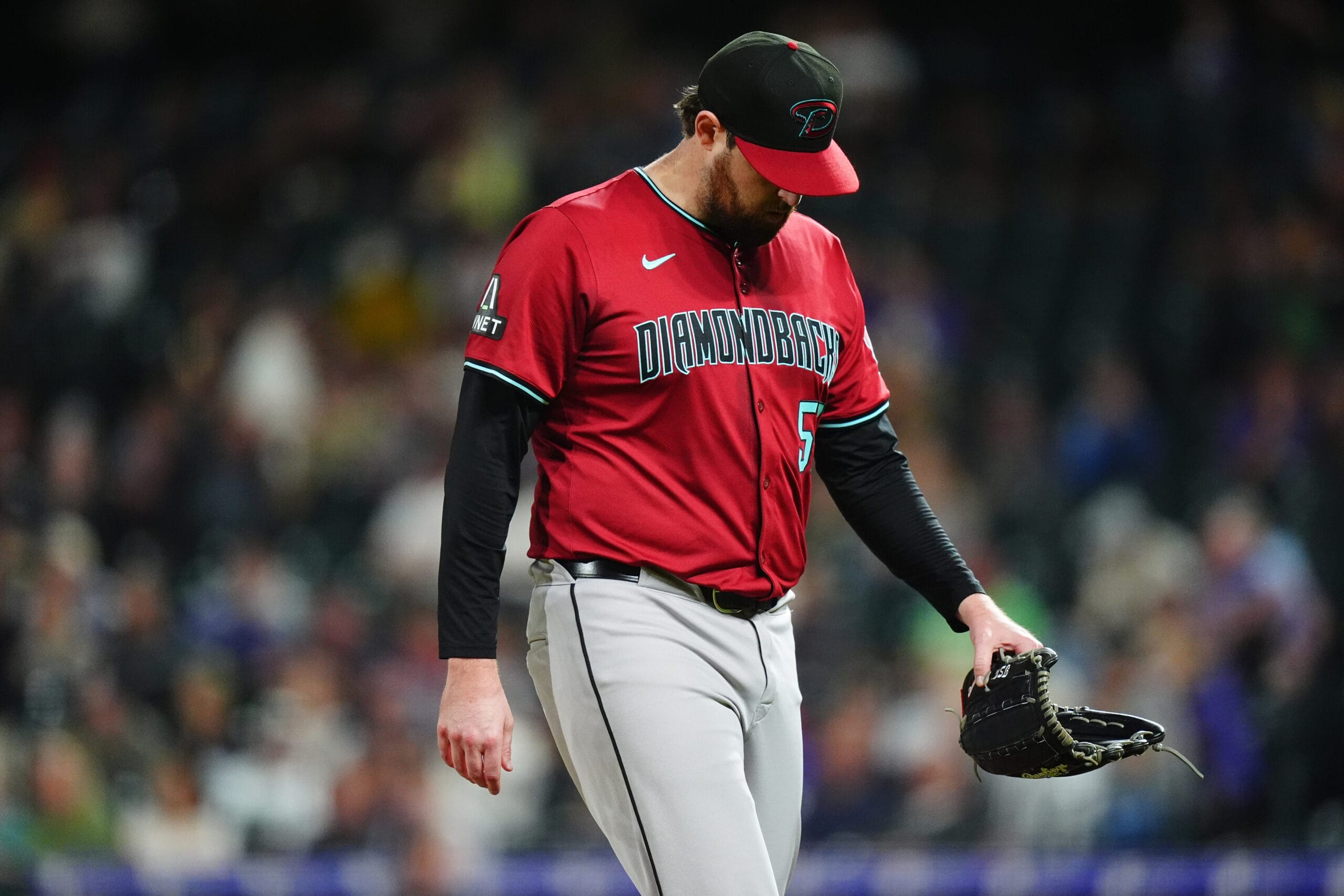 Diamondbacks starting pitcher Jordan Montgomery (52) leaves the mound in the fifth inning against the Colorado Rockies at Coors Field.