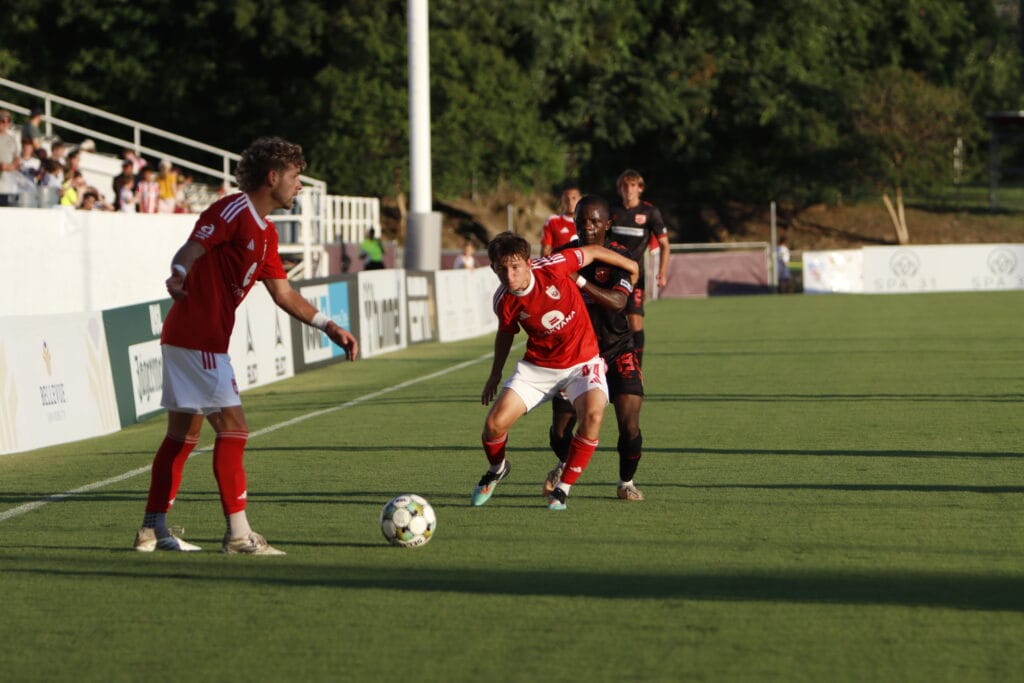 Jamison Ping of Phoenix Rising contends with a Texoma FC player